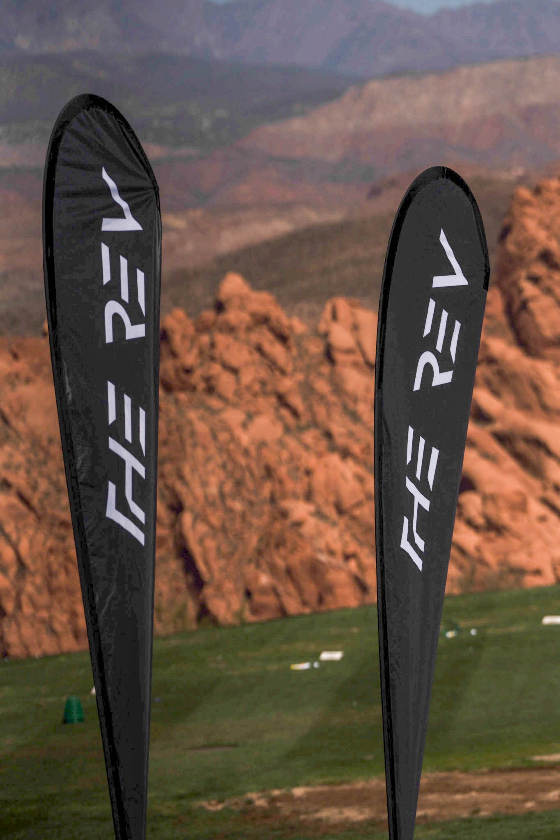 REV Tour flags with red rock backdrop