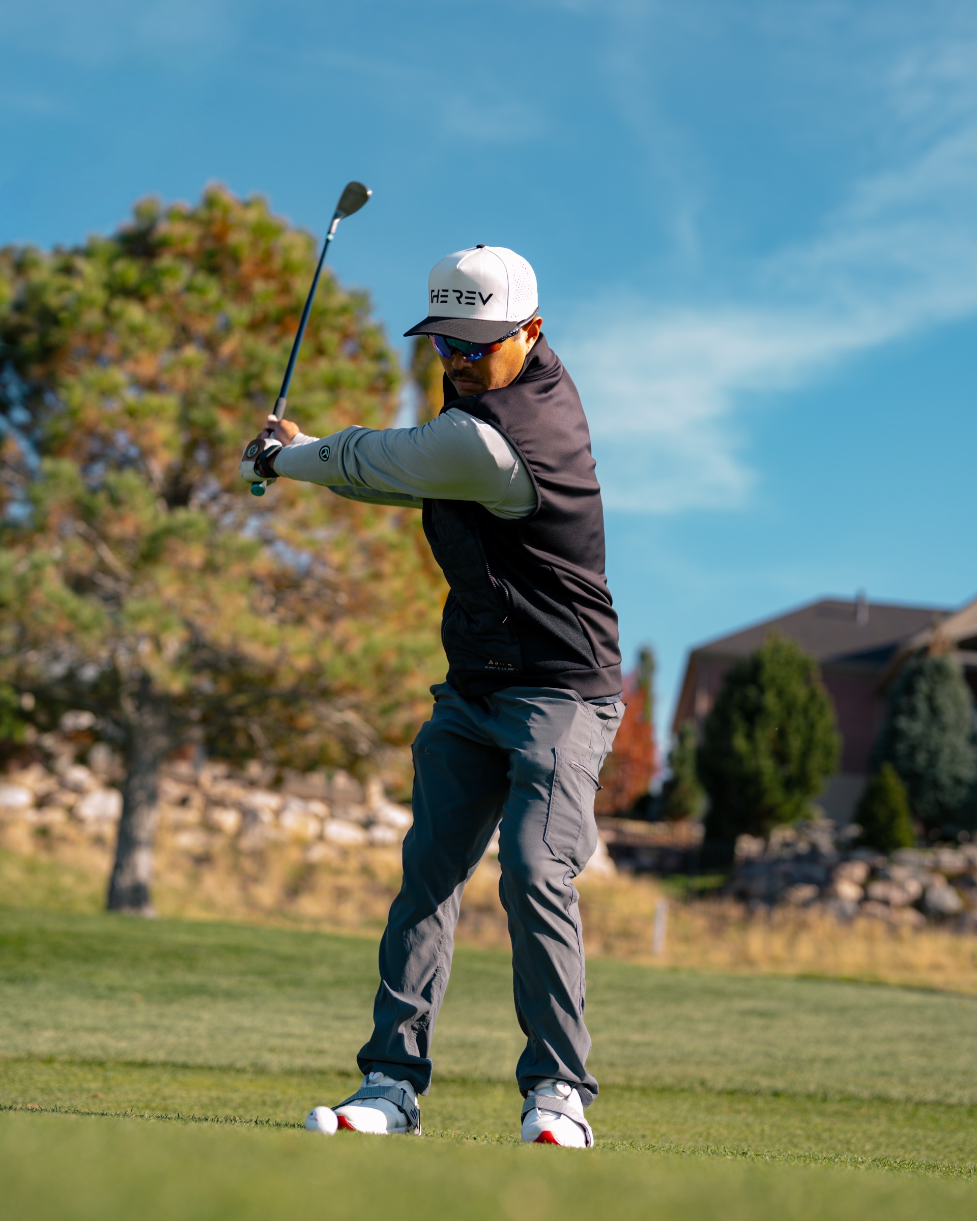REV Tour player mid-backswing